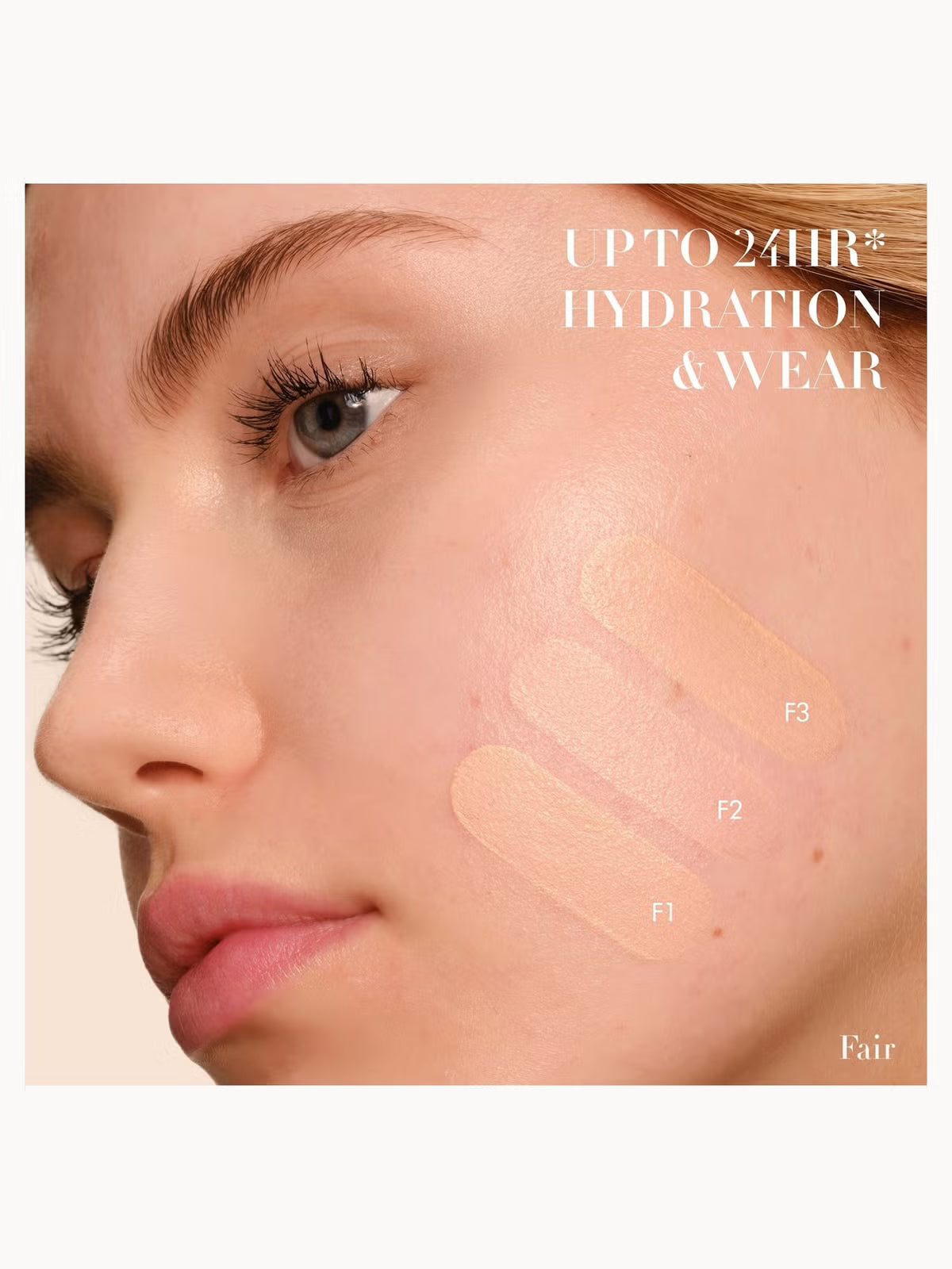 Close-up of a woman's face with three foundation swatches labeled F1, F2, and F3 on her cheek, plus text reading 'UPTO 24HR HYDRATION & WEAR' and 'Fair' on a light beige background.