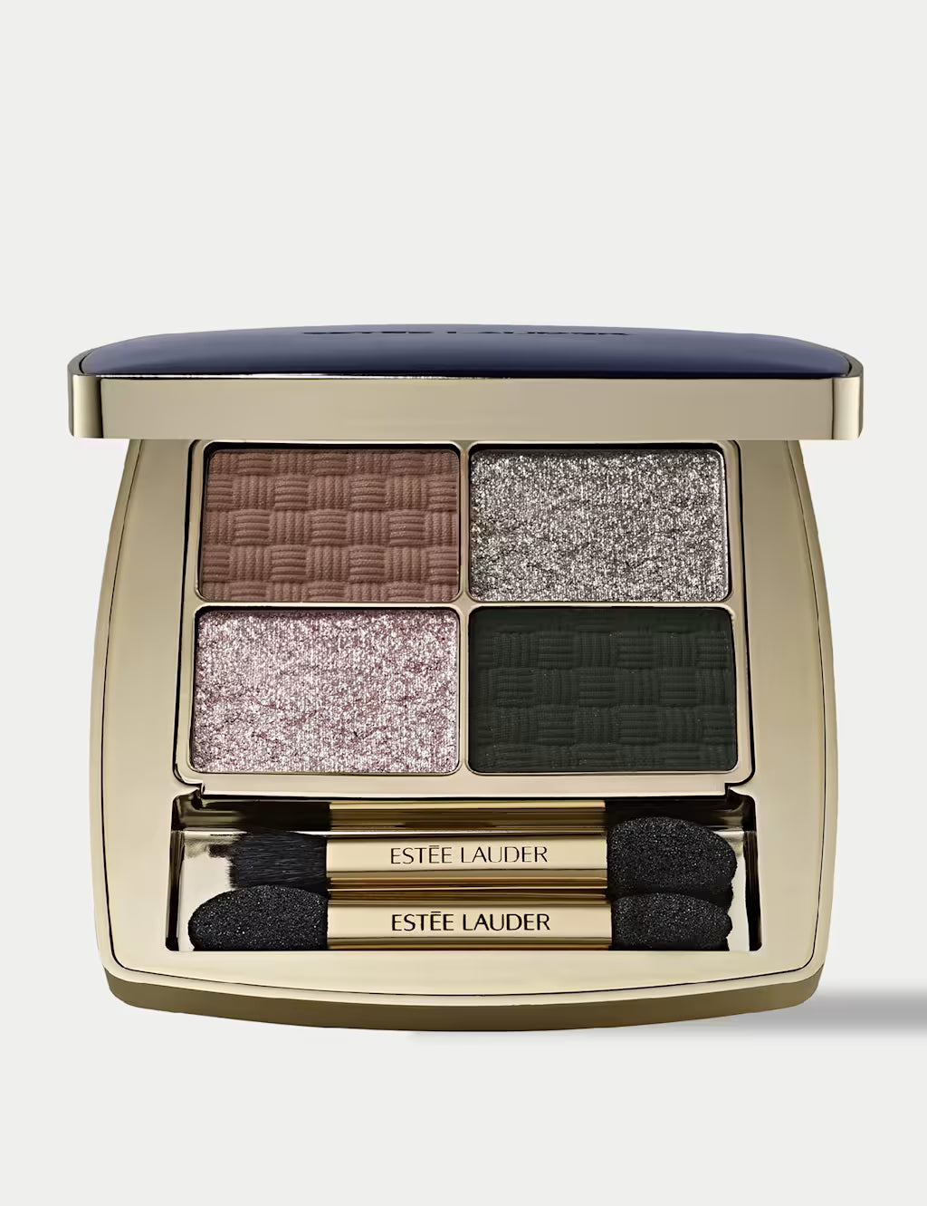 Estée Lauder Four-Way Quad Eye Shadow Getaway palette in a gold compact with a navy blue cushioned lid, showing four textured eyeshadow pans in brown, silver, pink, and dark green, with two applicators below.