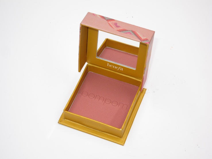 Benefit Pompom blush compact in a gold and pink box, shown open on a white background.